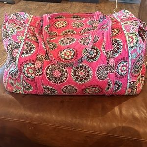 Vera Bradley travel bag with id tag. No pockets on inside one pocket on outside